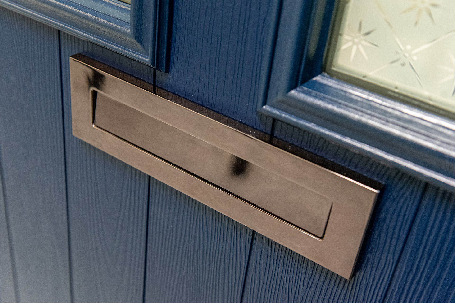 Pale blue Comp Door composite door with an arched fanlight and house number